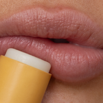 applying wild honey lip balm on lips