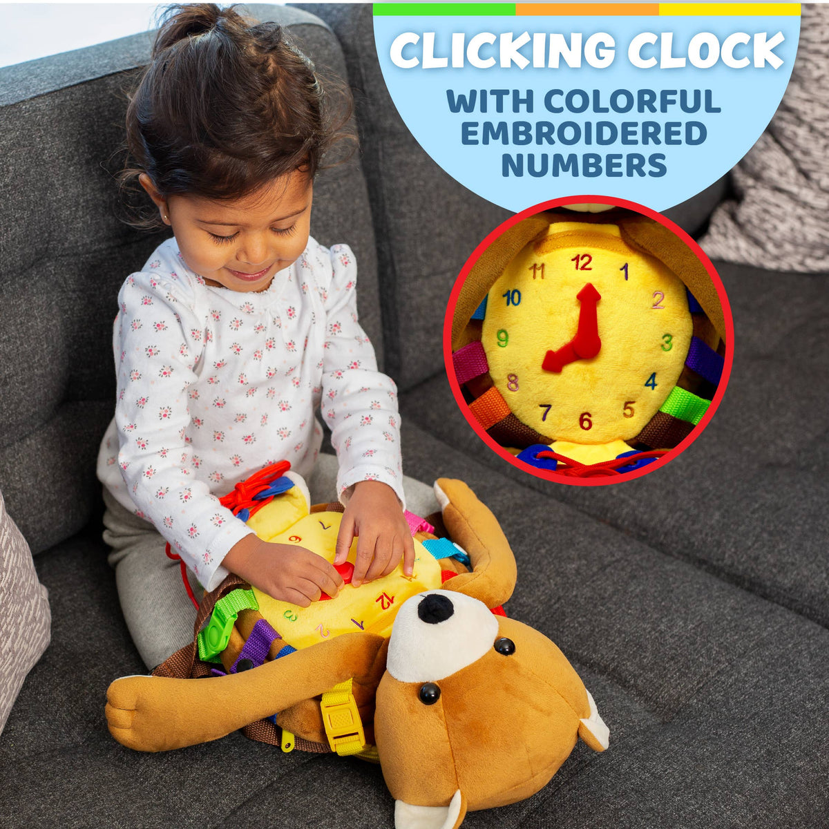 Toddler engaging with a baby sensory backpack featuring a clicking clock and colorful embroidered numbers.