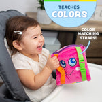 Baby happily playing with Plush Sensory Square Toy while riding in a carseat. 