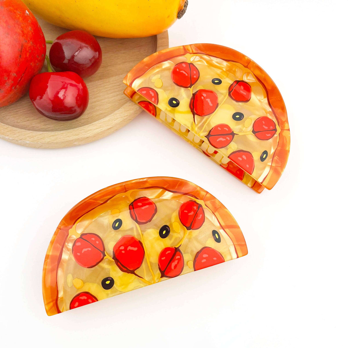 Pizza hair claw clip shaped like a ham pizza slice with toppings, perfect playful accessory for bold style.