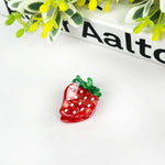 Strawberry hair clip featuring vibrant red design with white polka dots, perfect cute fruit hair accessory.