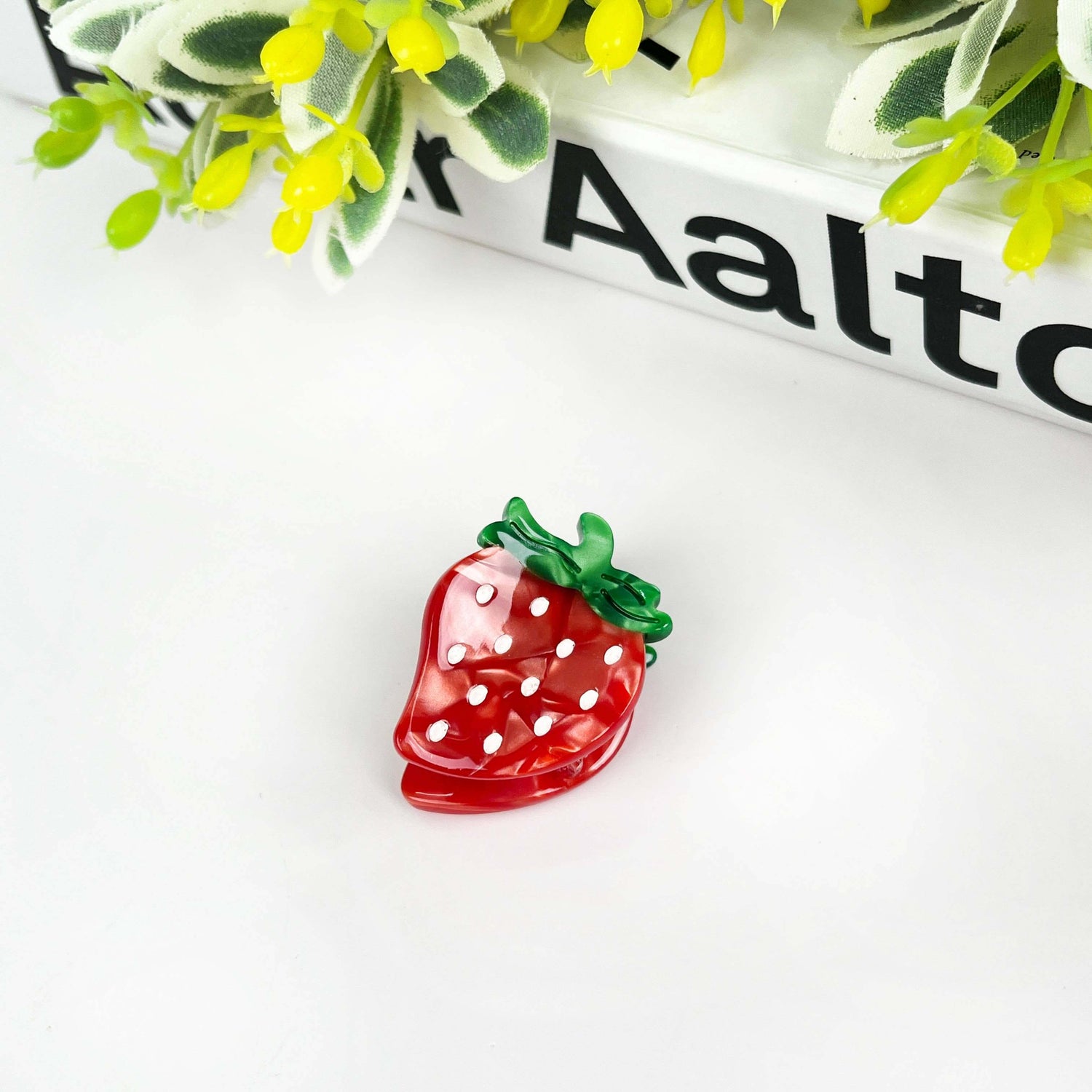 Strawberry hair clip featuring vibrant red design with white polka dots, perfect cute fruit hair accessory.