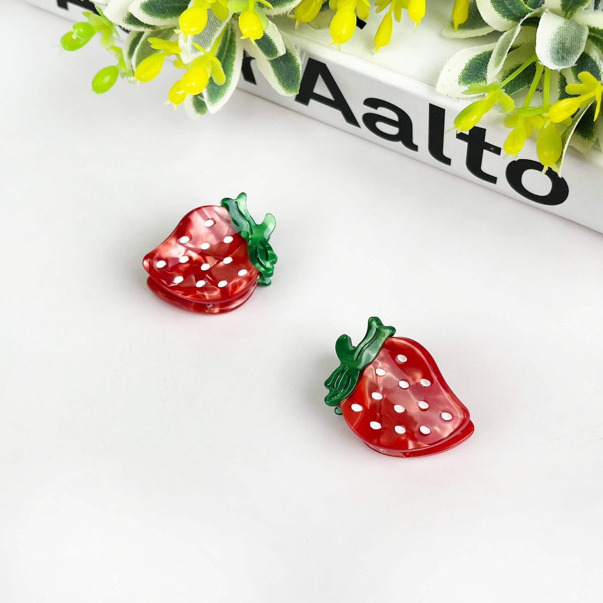 Strawberry hair clip featuring a vibrant strawberry design with polka dots, perfect for playful hairstyles.