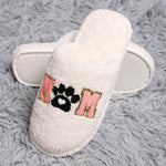 Cozy dog mom indoor slippers with soft white fabric and paw print design, perfect for dog lovers at home.
