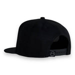 Back view of a black toddler snapback hat featuring a flat brim and adjustable strap.