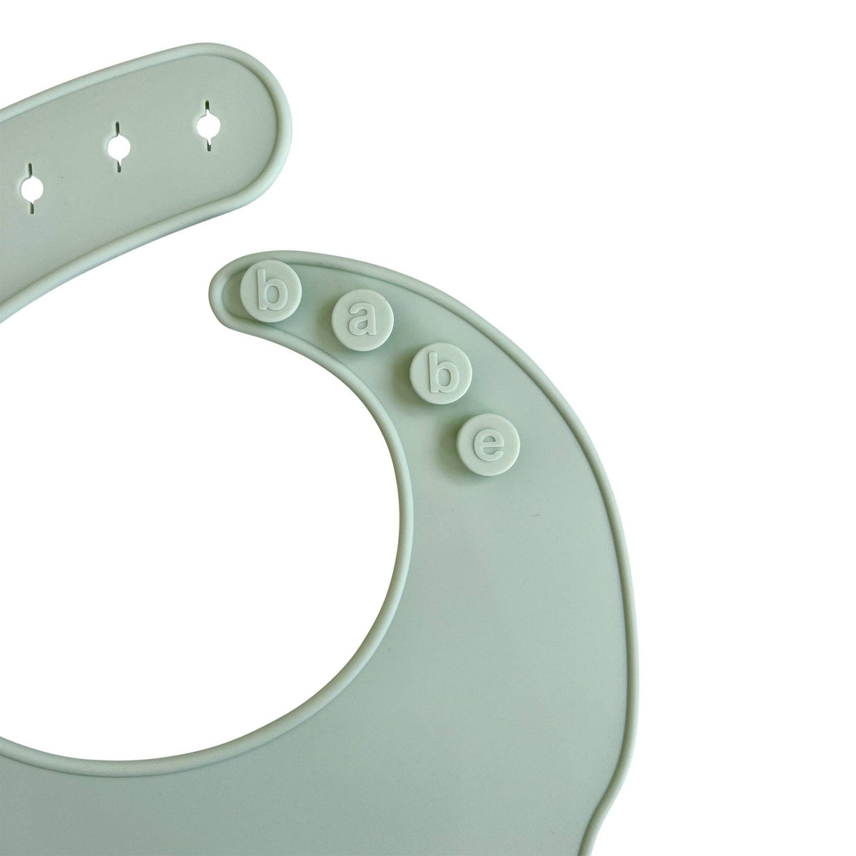 Silicone Baby Bib in a soft green color with alphabet letters spelling 'babe' on the front, designed for kids' mealtime.