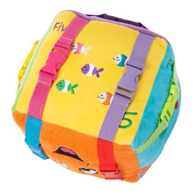 Plush sensory cube toy featuring colorful textures, snaps, and buckles for early learning and sensory play.