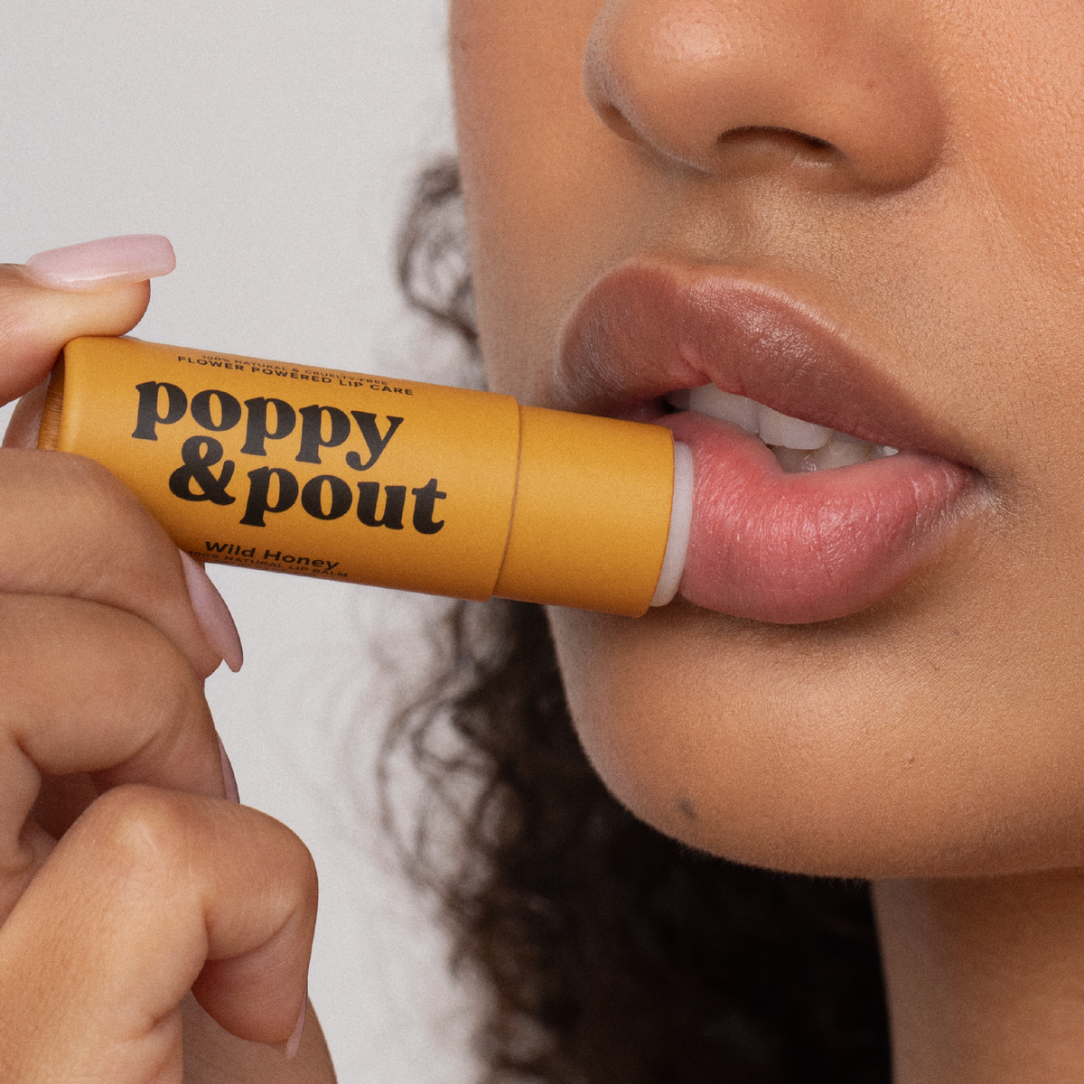 applying wild honey lip balm